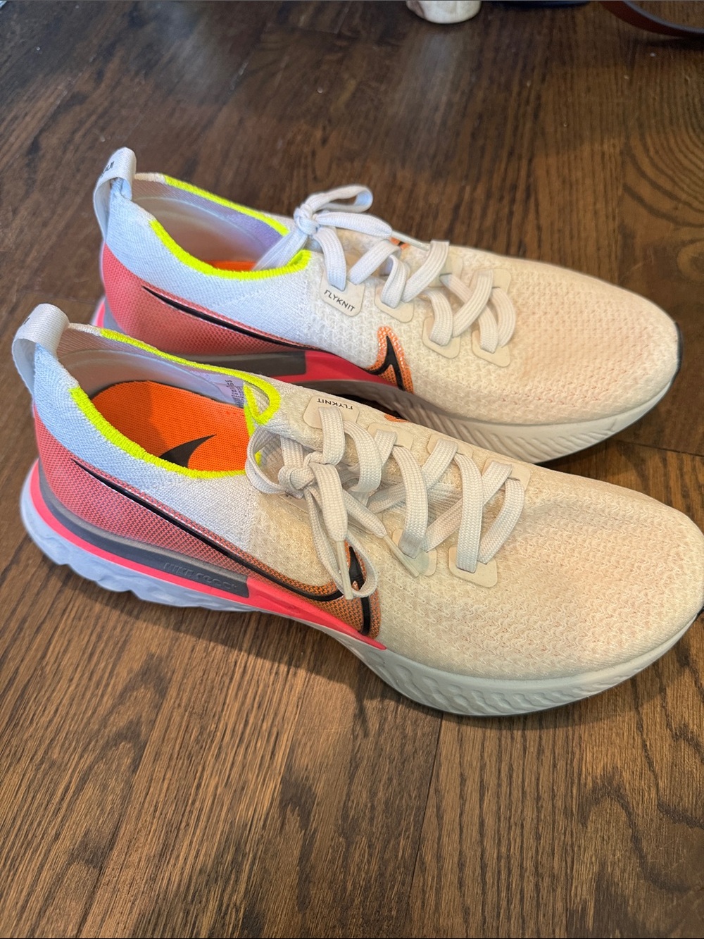Women’s Nike Flyknit White Running Sneakers with Neon Pink Accent